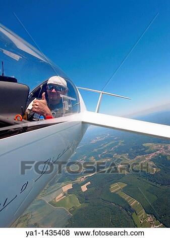 Happy glider pilot in flight over Lorraine region, France. Glider model's Duo-Discus. View Large Photo Image Stock Photo - Happy glider pilot in flight over Lorraine region, France. Glider model's Duo-Discus.. Fotosearch