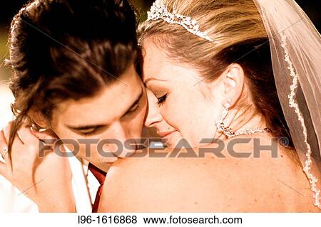happy groom kissing brides shoulder after wedding View Large Photo Image Stock Photo - happy groom kissing brides shoulder after wedding. Fotosearch