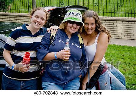 Happy group of women age 23 enjoying the day at a tailgating party, Grand Old Day Street Fair, St Paul, Minnesota, USA View Large Photo Image Stock Photo - Happy group of women age 23 enjoying the day at a tailgating party, Grand Old Day Street Fair, St Paul, Minnesota, USA. Fotosearch