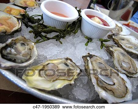 Happy hour menu, top neck clams and oysters at City Crab restaurant, Dowtown Manhattan, New York City, USA. View Large Photo Image Stock Photo - Happy hour menu, top neck clams and oysters at City Crab restaurant, Dowtown Manhattan, New York City, USA.. Fotosearch