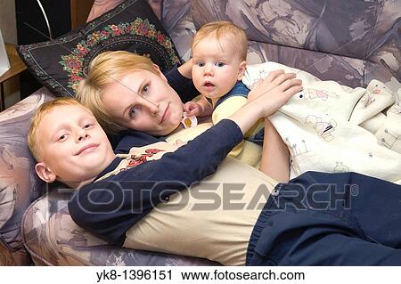 Happy Mother with Embracing Caucasian Kids, Family on Bed View Large Photo Image Stock Image - Happy Mother with Embracing Caucasian Kids, Family on Bed. Fotosearch