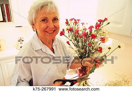 Happy senior woman with flowers View Large Photo Image Stock Image - Happy senior woman with flowers. Fotosearch