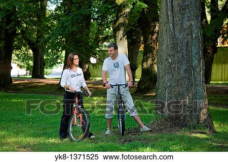 Happy Smiling Couple in Park with Bicycles, Estonia View Large Photo Image Stock Photography - Happy Smiling Couple in Park with Bicycles, Estonia. Fotosearch