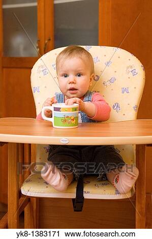 Happy Smiling Eight Month Old Infant Girl with Cup in High Chair View Large Photo Image Stock Image - Happy Smiling Eight Month Old Infant Girl with Cup in High Chair. Fotosearch