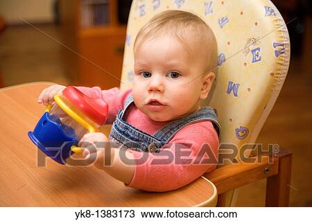 Happy Smiling Eight Month Old Infant Girl with Cup in High Chair View Large Photo Image Stock Image - Happy Smiling Eight Month Old Infant Girl with Cup in High Chair. Fotosearch