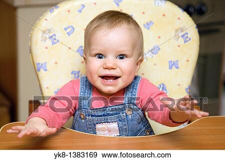 Happy Smiling Eight Month Old Infant Girl in High Chair View Large Photo Image Stock Photo - Happy Smiling Eight Month Old Infant Girl in High Chair. Fotosearch