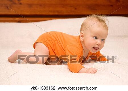 Happy Smiling Five month old baby crawling on bed View Large Photo Image Stock Image - Happy Smiling Five month old baby crawling on bed. Fotosearch