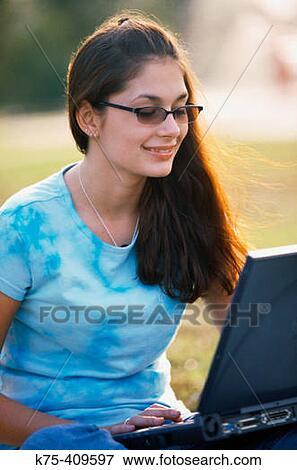 Stock Photo - Happy student working on laptop. Fotosearch