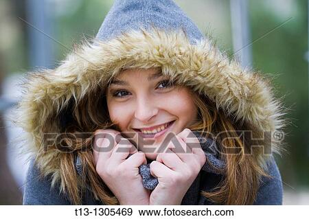 Happy teen girl warm under the hood View Large Photo Image Stock Photo - Happy teen girl warm under the hood. Fotosearch