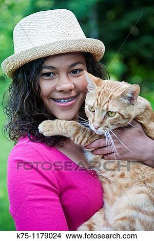 Happy teen with her pet cat View Large Photo Image Picture - Happy teen with her pet cat. Fotosearch