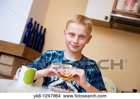 Happy Teenage Boy Eating Breakfest Sandwich in Kitchen View Large Photo Image Picture - Happy Teenage Boy Eating Breakfest Sandwich in Kitchen. Fotosearch