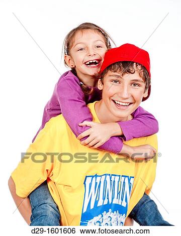 happy teenage boy giving his little sister piggy back ride - isolated on white View Large Photo Image Stock Photograph - happy teenage boy giving his little sister piggy back ride - isolated on white. Fotosearch