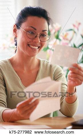 Stock Image - Happy to get a letter and a photo. Fotosearch