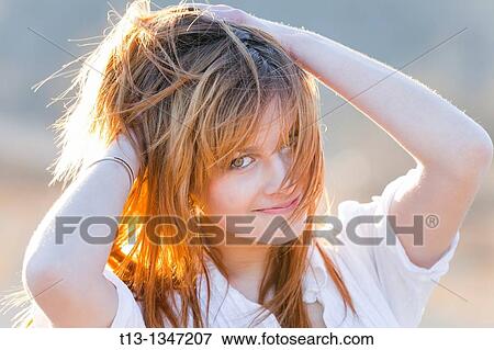 Happy with a messy hair young woman portrait View Large Photo Image Stock Photo - Happy with a messy hair young woman portrait. Fotosearch