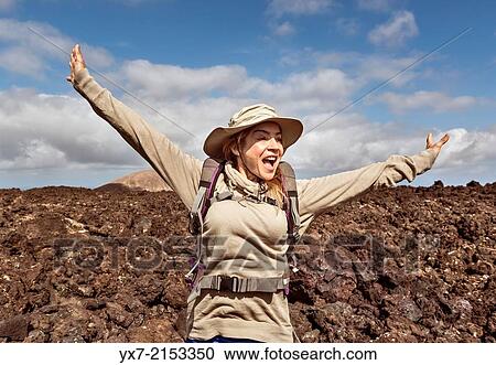 Happy woman hiking at Timanfaya National Park, Lanzarote, Canary Islands, Spain. View Large Photo Image Stock Image - Happy woman hiking at Timanfaya National Park, Lanzarote, Canary Islands, Spain.. Fotosearch