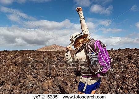 Happy woman hiking at Timanfaya National Park, Lanzarote, Canary Islands, Spain. View Large Photo Image Stock Image - Happy woman hiking at Timanfaya National Park, Lanzarote, Canary Islands, Spain.. Fotosearch