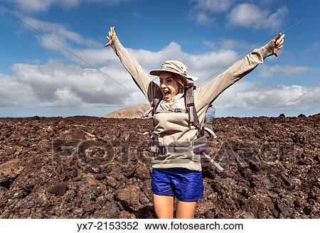 Happy woman hiking at Timanfaya National Park, Lanzarote, Canary Islands, Spain. View Large Photo Image Stock Image - Happy woman hiking at Timanfaya National Park, Lanzarote, Canary Islands, Spain.. Fotosearch