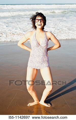 Stock Photo - Happy woman on the beach. Fotosearch
