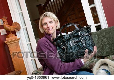 Stock Image - happy woman receiving gift. Fotosearch