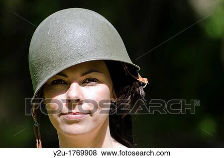 Stock Photo - Happy woman with military helmet. Fotosearch
