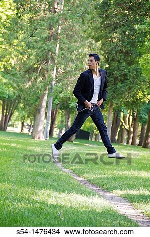 Happy young hispanic male outdoors View Large Photo Image Picture - Happy young hispanic male outdoors. Fotosearch