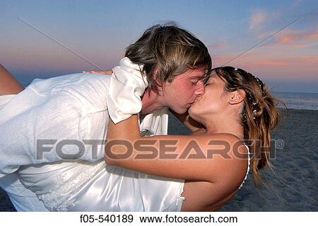 Happy young newly married couple kissing. View Large Photo Image Stock Photo - Happy young newly married couple kissing.. Fotosearch