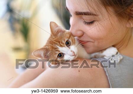 Happy young woman and red kitten View Large Photo Image Stock Photo - Happy young woman and red kitten. Fotosearch
