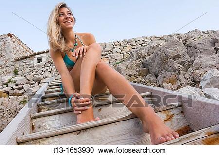Happy young woman on a wooden staircase View Large Photo Image Stock Image - Happy young woman on a wooden staircase. Fotosearch