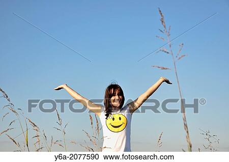 Happy young woman outdoors smiling arms outstretched. View Large Photo Image Stock Image - Happy young woman outdoors smiling arms outstretched.. Fotosearch