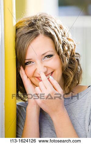 Happy young woman portrait touching nose with a finger View Large Photo Image Stock Photograph - Happy young woman portrait touching nose with a finger. Fotosearch