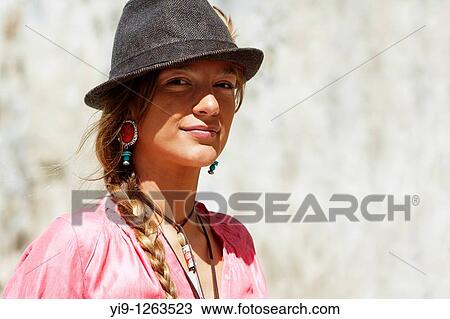 Stock Image - Happy young woman portrait with grey hat. Fotosearch