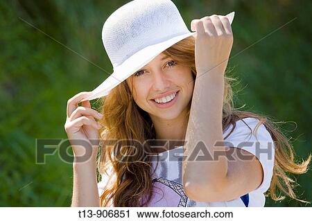 Happy young woman portrait with White hat View Large Photo Image Stock Image - Happy young woman portrait with White hat. Fotosearch
