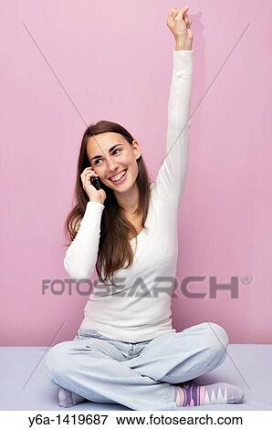 Happy young woman using cell phone View Large Photo Image Stock Photo - Happy young woman using cell phone. Fotosearch