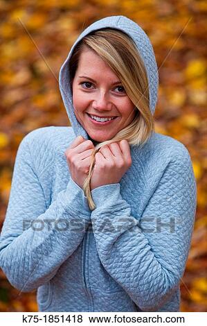 Happy young woman with hands on her hoodie View Large Photo Image Stock Photo - Happy young woman with hands on her hoodie. Fotosearch