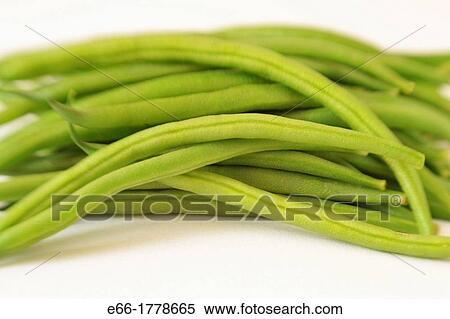 Stock Photography - Haricot verts green beans on white background Shot with Lensbaby for selective focus. Fotosearch