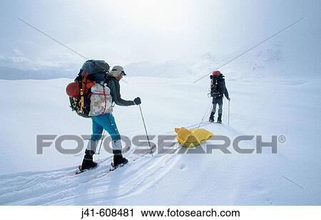 Stock Image - Hauling food depot, winter skiing on Lhagu Glacier at 4. 300 metres. Kangri Garpo Mountains. South Eastern Tibet. Fotosearch