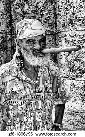 Havana capitol city of Cuba closeup of older man character with long cigar and scarf in Old Havana View Large Photo Image Stock Photograph - Havana capitol city of Cuba closeup of older man character with long cigar and scarf in Old Havana. Fotosearch