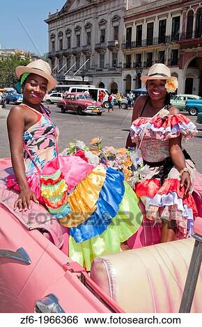 Havana Cuba local women with flowers at Capital in pink Classic Ford auto and hats smiling for tourists. View Large Photo Image Stock Photograph - Havana Cuba local women with flowers at Capital in pink Classic Ford auto and hats smiling for tourists.. Fotosearch