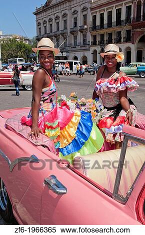 Havana Cuba local women with flowers at Capital in pink Classic Ford auto and hats smiling for tourists. View Large Photo Image Stock Photography - Havana Cuba local women with flowers at Capital in pink Classic Ford auto and hats smiling for tourists.. Fotosearch
