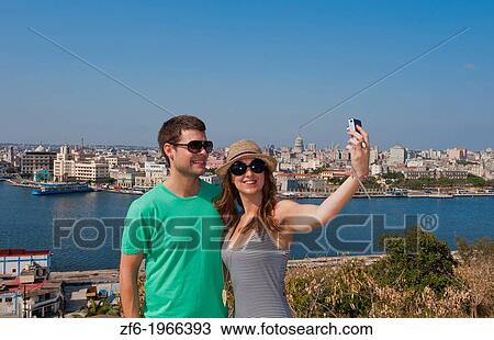 Havana Cuba skyline panoramic view of river and entire city from Christ statue above city in Caribbean with tourist couple taking photo on holiday. View Large Photo Image Stock Image - Havana Cuba skyline panoramic view of river and entire city from Christ statue above city in Caribbean with tourist couple taking photo on holiday.. Fotosearch