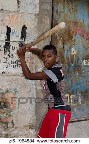 Havana Cuba young boy aged 13 hitting baseballs on street in downtown city center with bat. View Large Photo Image Picture - Havana Cuba young boy aged 13 hitting baseballs on street in downtown city center with bat.. Fotosearch