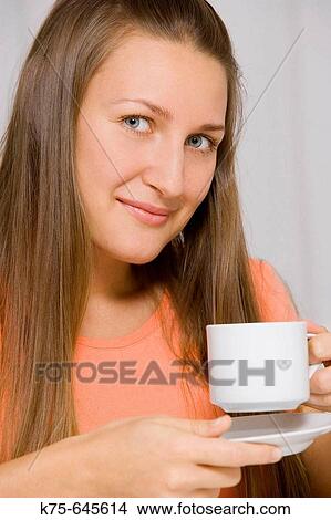 Having a cup of hot beverage View Large Photo Image Picture - Having a cup of hot beverage. Fotosearch