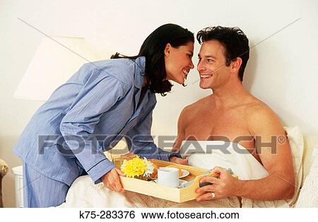 Stock Photograph - he gets breakfast in bed. Fotosearch