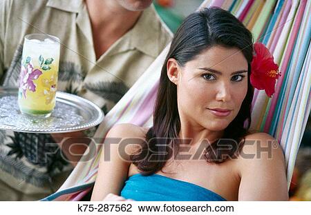 He serves her a tropical drink View Large Photo Image Stock Image - He serves her a tropical drink. Fotosearch