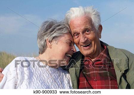 Head and shoulder photograph of elderly caucasian couple laughing and leaning to eachother while the senior man is looking into the camera, Island of Amrum, Northfrisian, Schleswig_Holstein, Northern Germany, Europe View Large Photo Image Stock Image - Head and shoulder photograph of elderly caucasian couple laughing and leaning to eachother while the senior man is looking into the camera, Island of Amrum, Northfrisian, Schleswig_Holstein, Northern Germany, Europe. Fotosearch
