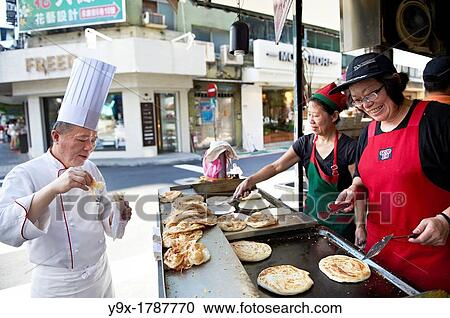 Head Chef Huang Lai Fa of The Grand Formosa Regent Hotel Taipei, posing and sampling food on Yongkang Street in Taipei, Taiwan View Large Photo Image Stock Image - Head Chef Huang Lai Fa of The Grand Formosa Regent Hotel Taipei, posing and sampling food on Yongkang Street in Taipei, Taiwan. Fotosearch
