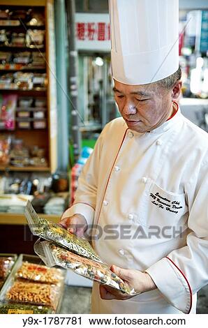 Head Chef Huang Lai Fa of The Grand Formosa Regent Hotel Taipei, posing and sampling food on Yongkang Street in Taipei, Taiwan View Large Photo Image Stock Image - Head Chef Huang Lai Fa of The Grand Formosa Regent Hotel Taipei, posing and sampling food on Yongkang Street in Taipei, Taiwan. Fotosearch
