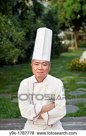 Head Chef Huang Lai Fa of The Grand Formosa Regent Hotel Taipei, posing and sampling food on Yongkang Street in Taipei, Taiwan View Large Photo Image Stock Photo - Head Chef Huang Lai Fa of The Grand Formosa Regent Hotel Taipei, posing and sampling food on Yongkang Street in Taipei, Taiwan. Fotosearch