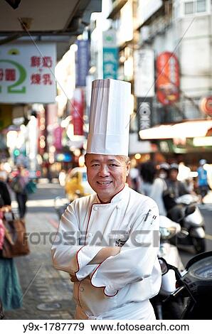 Head Chef Huang Lai Fa of The Grand Formosa Regent Hotel Taipei, posing and sampling food on Yongkang Street in Taipei, Taiwan View Large Photo Image Stock Photo - Head Chef Huang Lai Fa of The Grand Formosa Regent Hotel Taipei, posing and sampling food on Yongkang Street in Taipei, Taiwan. Fotosearch