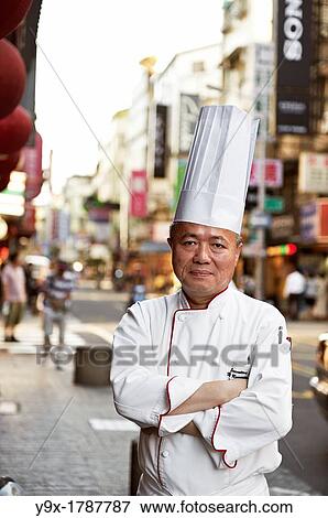 Head Chef Huang Lai Fa of The Grand Formosa Regent Hotel Taipei, posing and sampling food on Yongkang Street in Taipei, Taiwan View Large Photo Image Stock Photo - Head Chef Huang Lai Fa of The Grand Formosa Regent Hotel Taipei, posing and sampling food on Yongkang Street in Taipei, Taiwan. Fotosearch